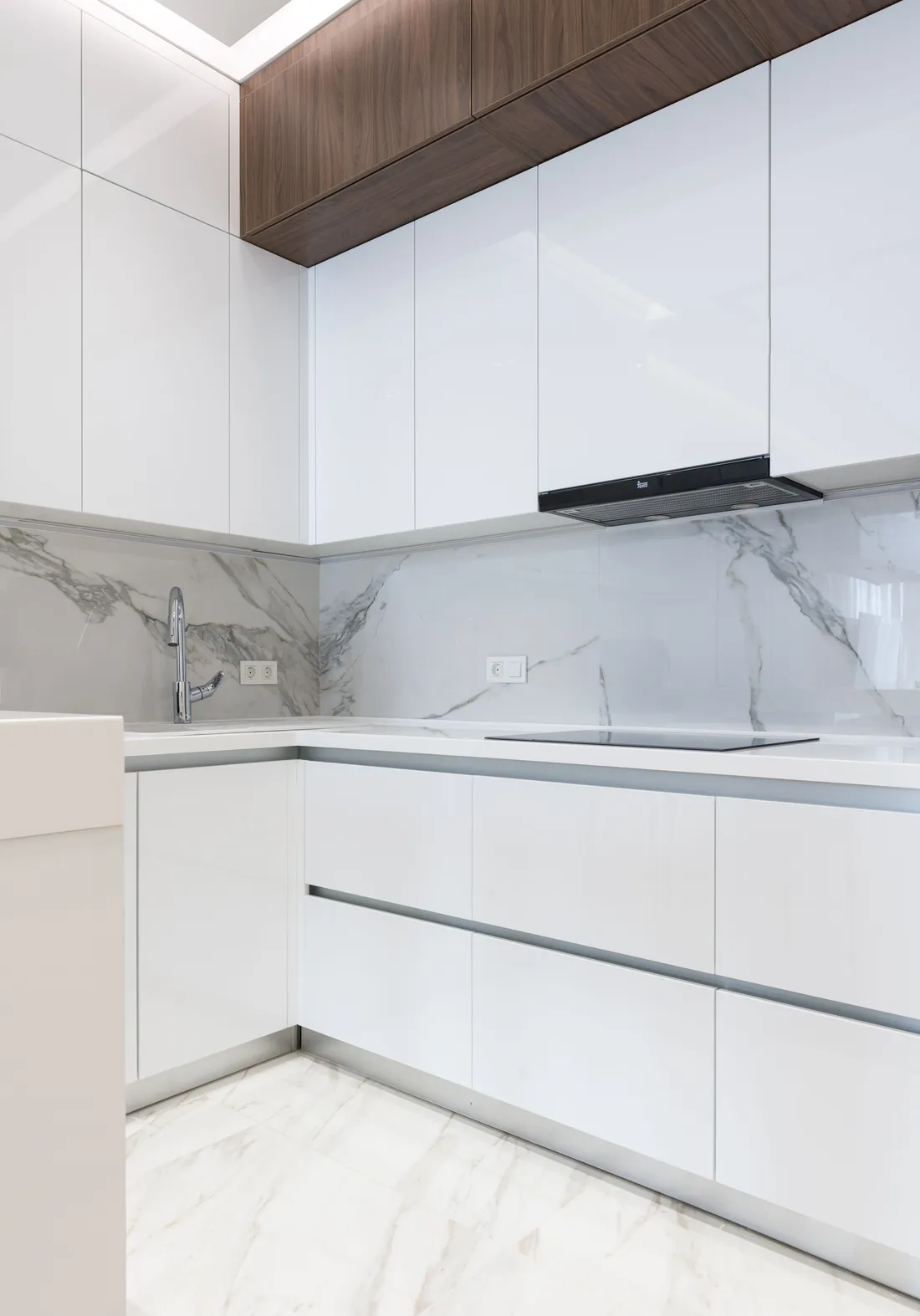 Stock photo: white kitchen cabinets beside wood and marble finishes; not company work.